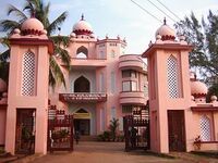 Ornate, pink-and-white building with traditional Mughal architecture