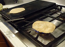 Chapati cooked on open-flame after being cooked on tava.