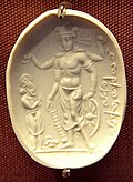 Vishnu Nicolo Seal representing Vishnu with a worshipper (probably Mihirakula), 4th–6th century CE. The inscription in cursive Bactrian reads: "Mihira, Vishnu and Shiva". British Museum.