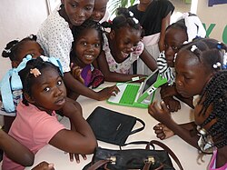photo of a group of children being introduced to a laptop