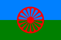 Flag of the Romani People. It contains blue and red colour to represent the heaven and earth respectively, and uses a 16 spoke Dharmachakra to symbolise their tradition and to pay homage to their Indian origin.