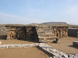 Stupa base at Sirkap, decorated with Hindu, Buddhist and Greek temple fronts.