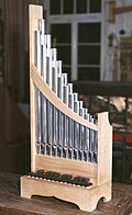 cf. Portative organ (portable pipe organ with bellows)