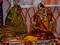 Bride with floral decorations for Haldi, Mehandi or Sangeet ceremony, part of pre-wedding rituals in South Asia.