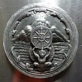Seal of Chai Nat Province (a garuda upholding the dhammacakka in front of the mountain and river), Wat Sri Suphan, Chiang Mai, Thailand.