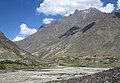 Village on a river beneath a mountain range, '09