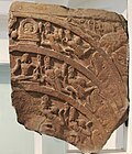Decorated tympanum showing the Bodhisattva Maitreya, from Jamalpur Tila, Mathura, 150 CE.[182]
