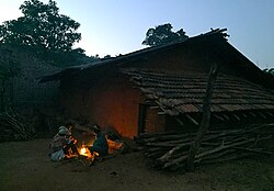 A Bonda family basking near a fire in Mudulipada