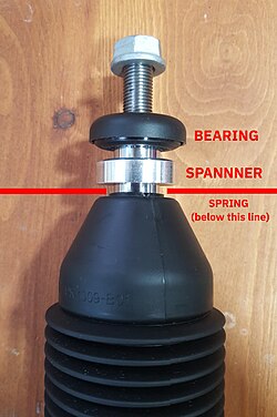 An extra aluminium spanner / distancing block is placed between the bearing and the top coil plate.