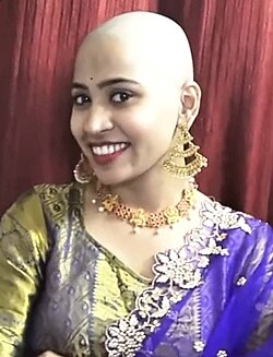 An Indian woman's head shaving as an act of Hindu religious devotion.jpg