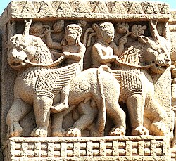 Foreigners holding grapes and riding winged lions, Sanchi Stupa 1, Eastern Gateway.[5]