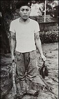 Same Iban headhunter posing with a human scalp