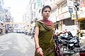 A Nepali in a modern style of draping dupatta over the neck.