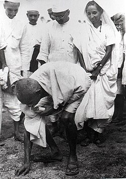 Mahatma Gandhi picking salt at Dandi beach, South Gujarat, ending the Salt satyagraha on 5 April 1930
