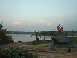Quiet waterfront in Solapur, with a statue in the foreground