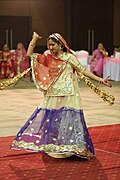 Woman with a ghoonghat performing a Ghumar dance.