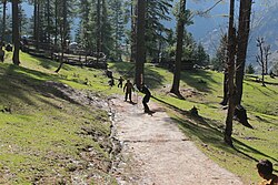 Photo showing children playing tape ball cricket near Pakistani mountains