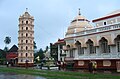 A photo showing the Gopuram, temple and Deep Stambha.