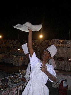 A chef preparing Rumali roti