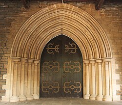Buff-coloured basalt and limestone doorway to the CNI Afghan Church[192]