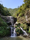 It is the falls at Rock Gardens in Darjeeling, West Bengal. It looks very beautiful on rainy days.