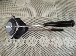 A tool with two long handles to open a space that can fit a sandwich