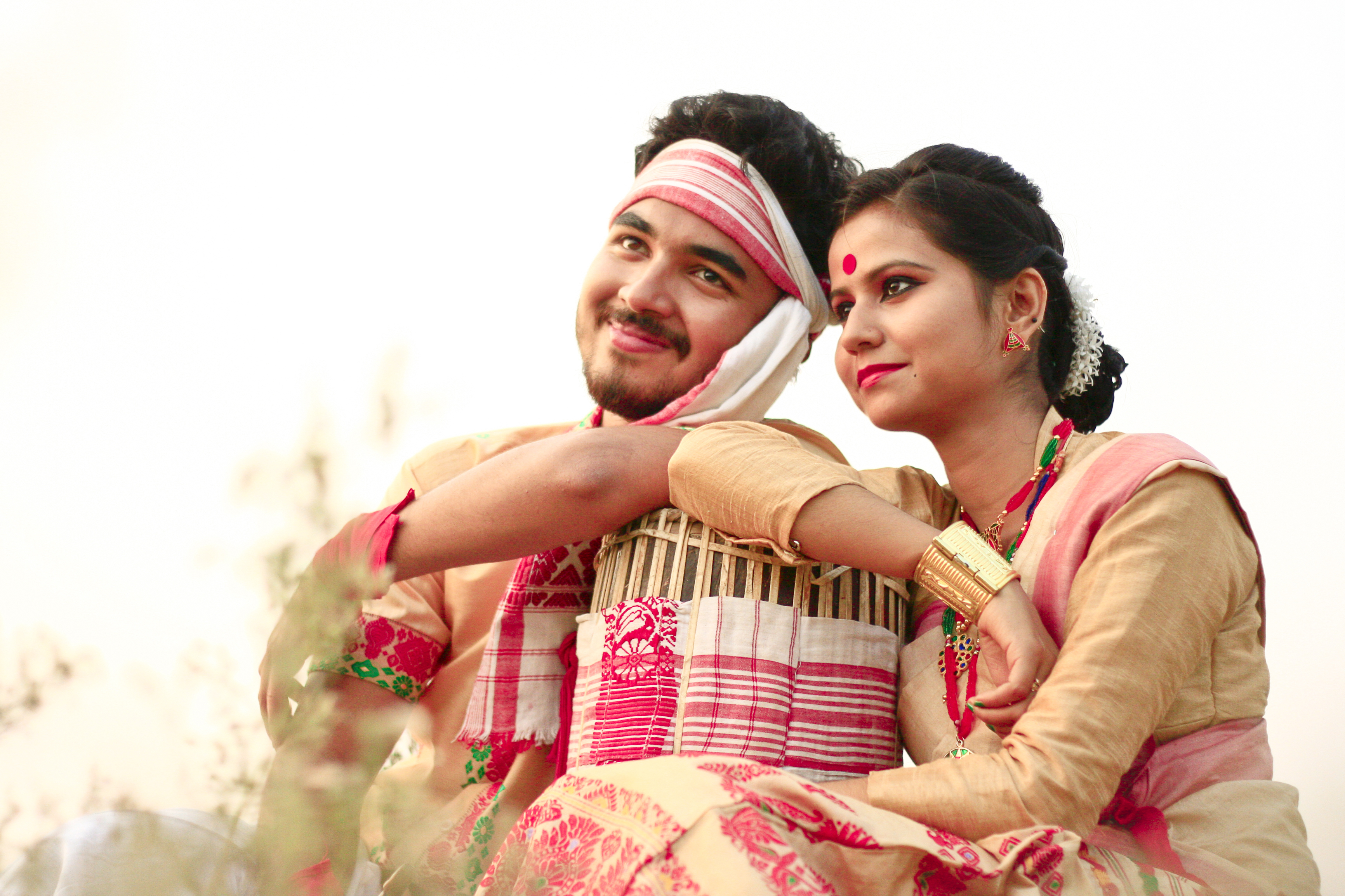 Assamese youth in traditional festive dress. The girl is wearing mekhela sador and bindi on the centre of her forehead.