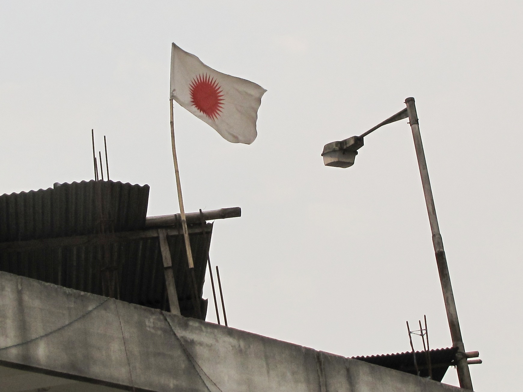 Donyi-Polo flag seen over a house in Itanagar, Arunachal Pradesh, India, indicating that its inhabitants follow the religion.